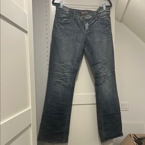 Low rise, distressed boot cut designer jeans